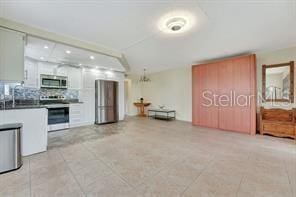 kitchen with white cabinets, backsplash, and appliances with stainless steel finishes