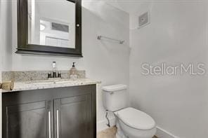 bathroom featuring toilet and vanity