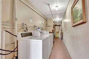 clothes washing area with washing machine and clothes dryer