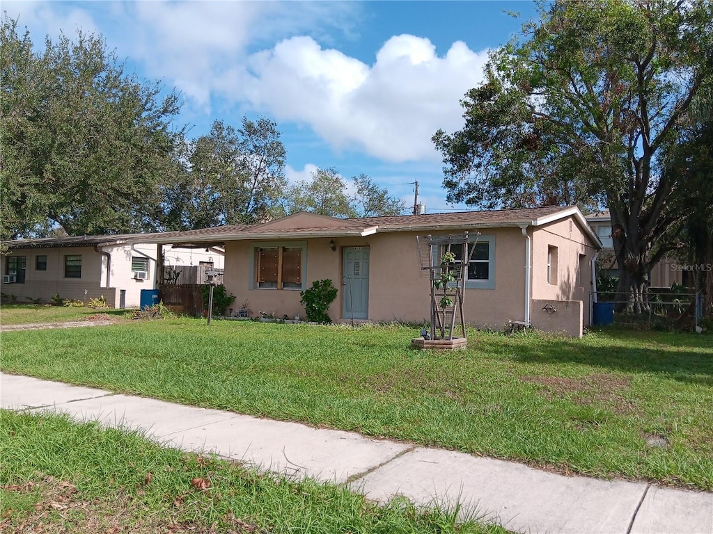 ranch-style home with a front lawn