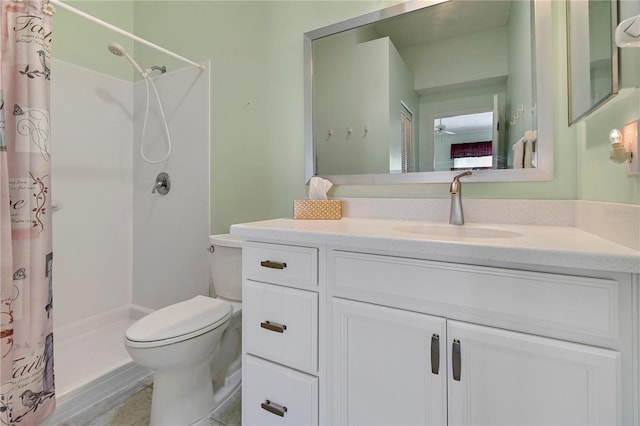 bathroom featuring ceiling fan, toilet, vanity, and walk in shower