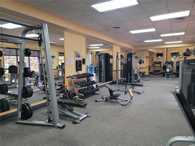 exercise room featuring a paneled ceiling