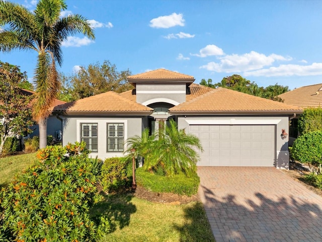 mediterranean / spanish-style home with a garage