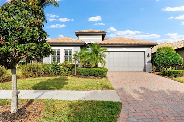 mediterranean / spanish home with a garage and a front yard