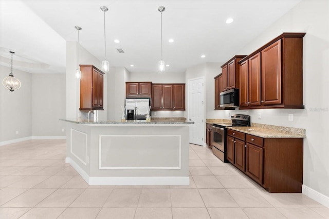 kitchen with hanging light fixtures, light stone countertops, light tile patterned flooring, and appliances with stainless steel finishes