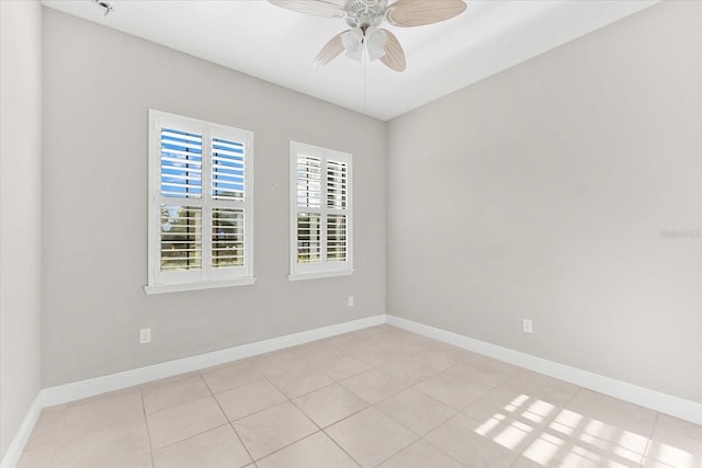 tiled spare room featuring ceiling fan