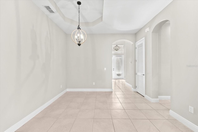 unfurnished dining area with an inviting chandelier and light tile patterned floors