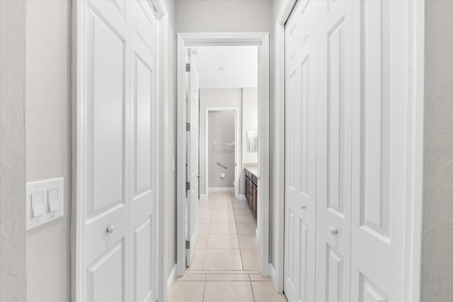 hall with light tile patterned floors