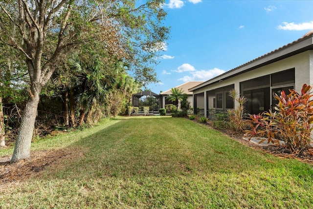 view of yard featuring a sunroom