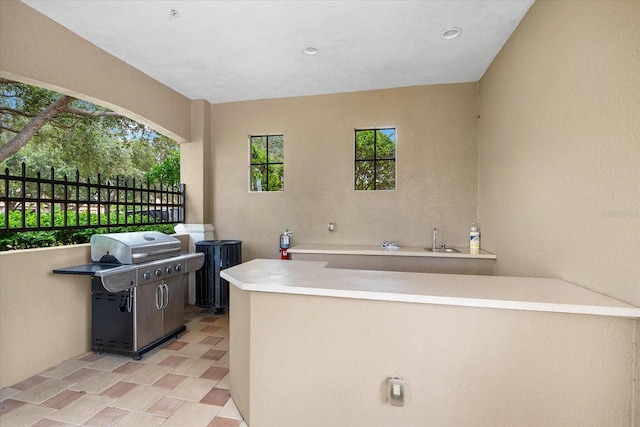 view of patio featuring a grill and sink