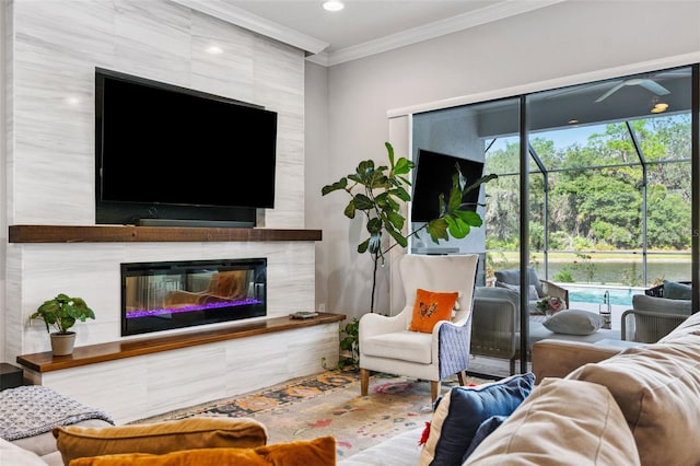 living room with crown molding and a fireplace