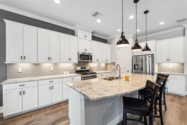 kitchen featuring light hardwood / wood-style floors, white cabinetry, sink, and appliances with stainless steel finishes