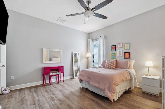 bedroom with light hardwood / wood-style flooring and ceiling fan