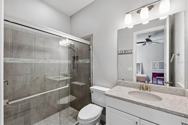 bathroom with ceiling fan, toilet, vanity, and walk in shower