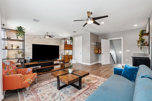 living room with hardwood / wood-style flooring and ceiling fan