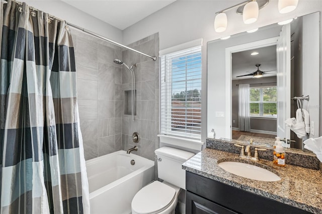 full bathroom featuring ceiling fan, shower / bath combo with shower curtain, vanity, and toilet