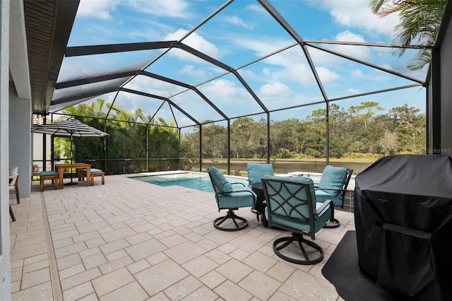 view of patio with glass enclosure and a grill