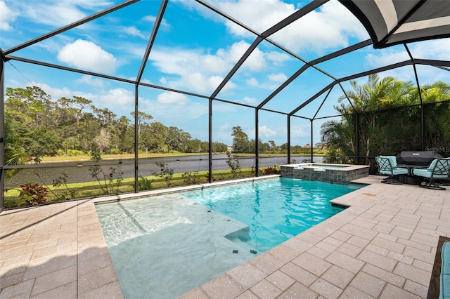 view of pool featuring glass enclosure, an in ground hot tub, and a patio