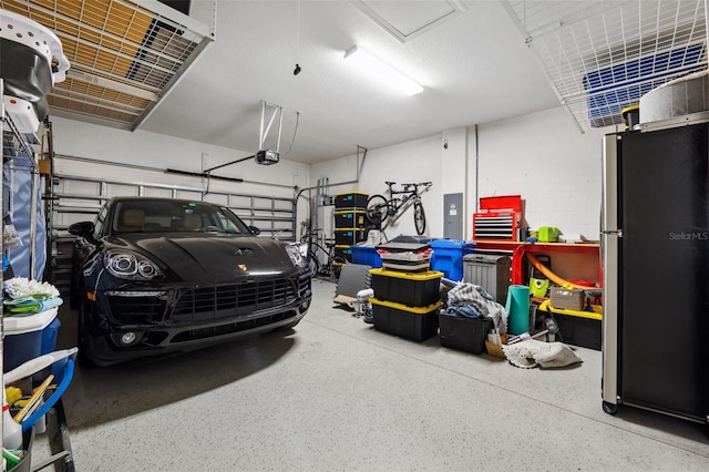 garage featuring electric panel, stainless steel refrigerator, and a garage door opener