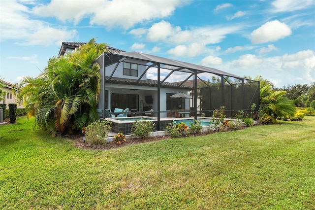 back of house with a swimming pool with hot tub, a yard, and a lanai