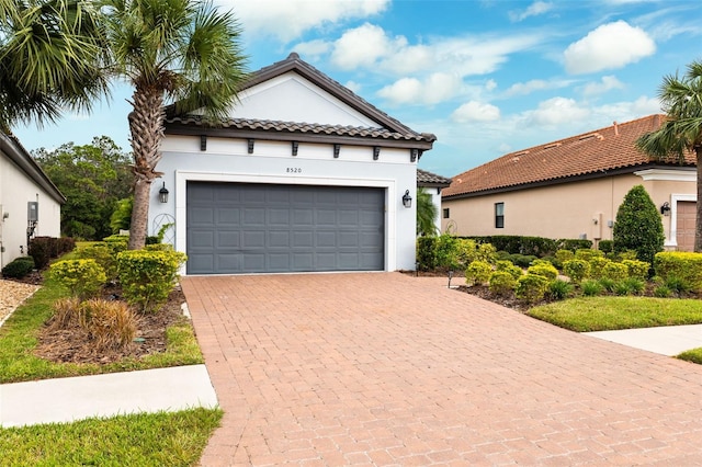 mediterranean / spanish-style home with a garage