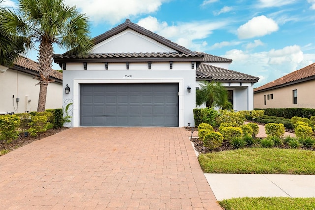 mediterranean / spanish house with a garage