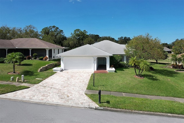 single story home with a garage and a front yard