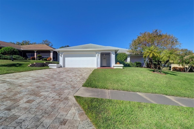 single story home featuring a front lawn and a garage