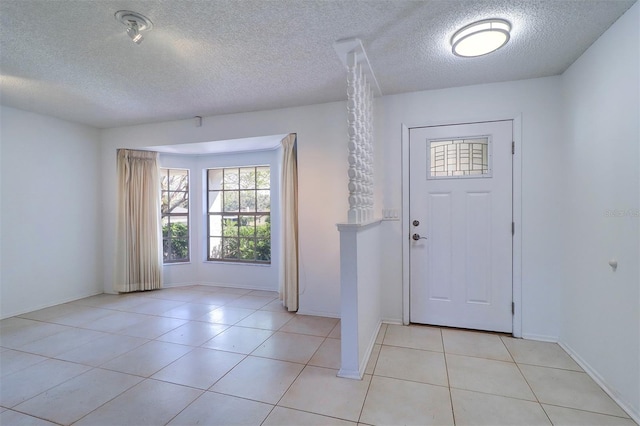 tiled foyer entrance with a textured ceiling