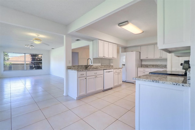 kitchen with white cabinets, kitchen peninsula, sink, and white appliances