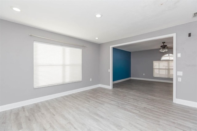 empty room featuring light wood-type flooring and ceiling fan