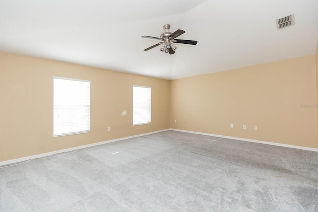 carpeted empty room featuring ceiling fan and vaulted ceiling