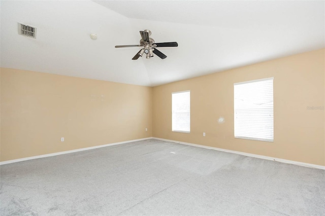 carpeted empty room with ceiling fan and lofted ceiling