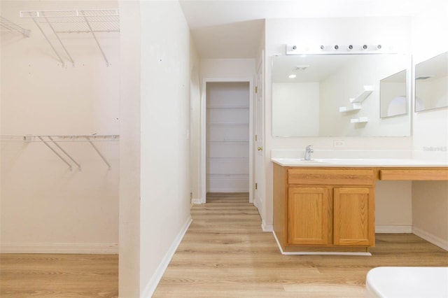 bathroom with vanity and hardwood / wood-style flooring