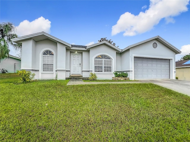 single story home featuring a garage and a front lawn