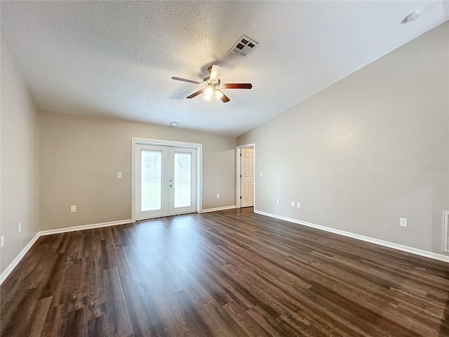 spare room with french doors, a textured ceiling, dark hardwood / wood-style flooring, lofted ceiling, and ceiling fan