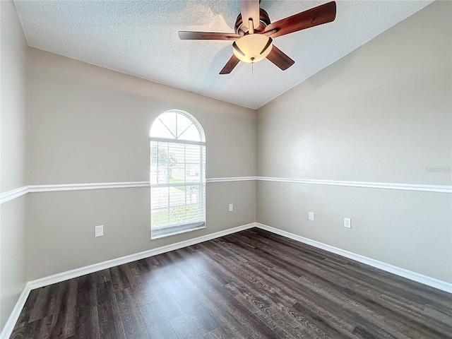 spare room featuring a textured ceiling, dark wood-type flooring, and ceiling fan