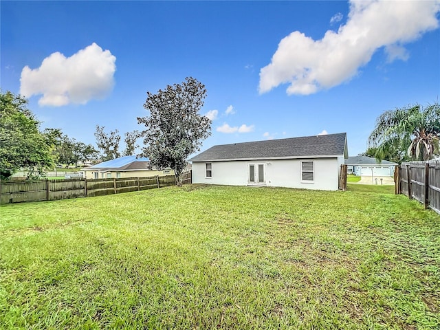 rear view of house featuring a lawn