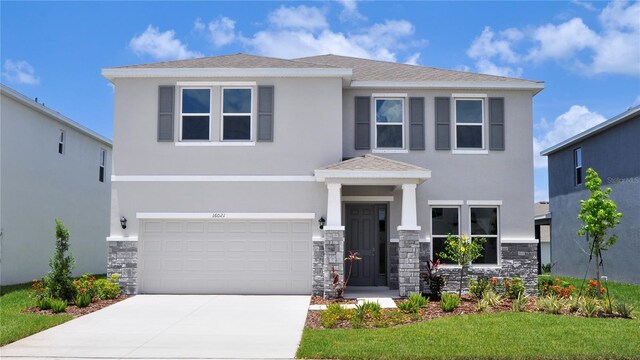16021 7th Ave E, Bradenton, FL 34212 - view of front of property featuring stone siding, stucco siding, concrete driveway, and a garage