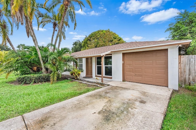 single story home featuring a garage and a front yard