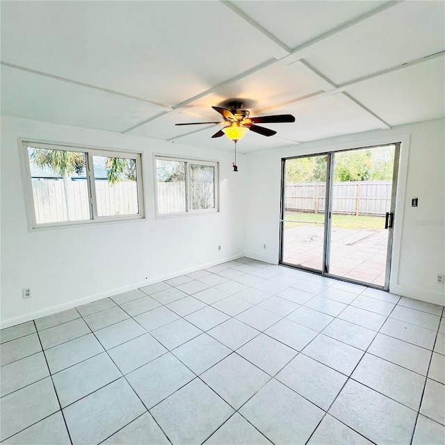 tiled spare room featuring ceiling fan