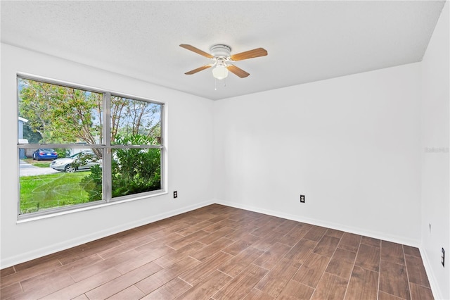 spare room with ceiling fan and hardwood / wood-style flooring