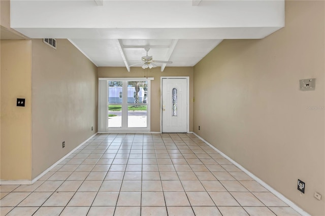 tiled entrance foyer with beam ceiling and ceiling fan