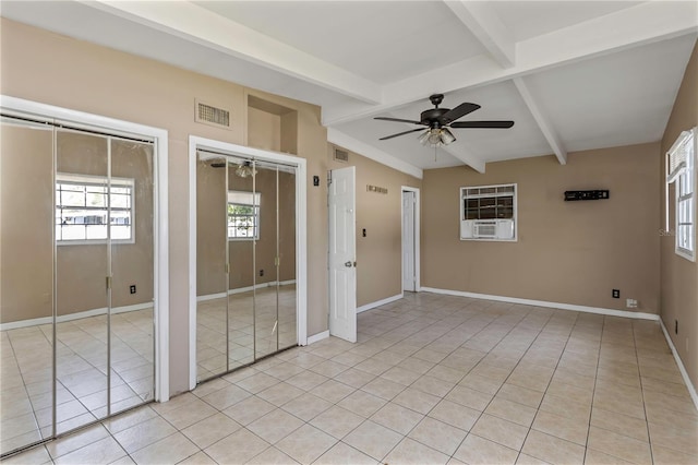 spare room featuring cooling unit, vaulted ceiling with beams, ceiling fan, and light tile patterned floors