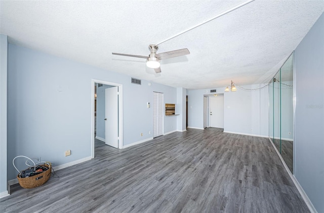 interior space featuring a textured ceiling, hardwood / wood-style flooring, and ceiling fan