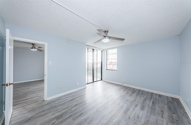 unfurnished room with a textured ceiling, hardwood / wood-style flooring, and ceiling fan