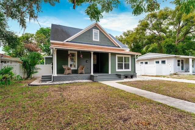 view of front of property with a porch and a front yard