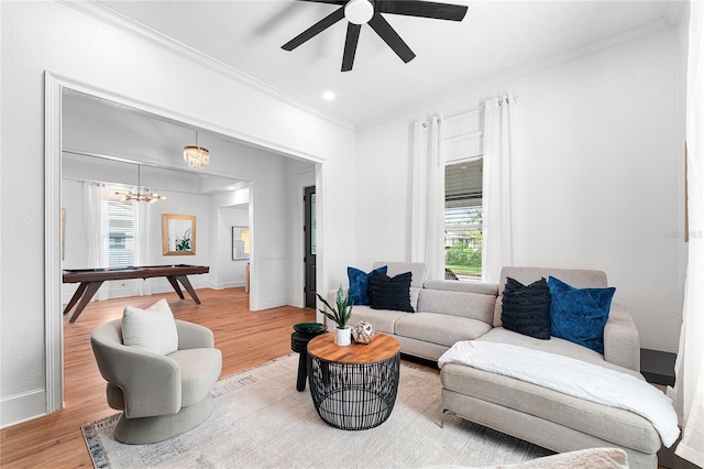 living room with hardwood / wood-style floors, a healthy amount of sunlight, and crown molding