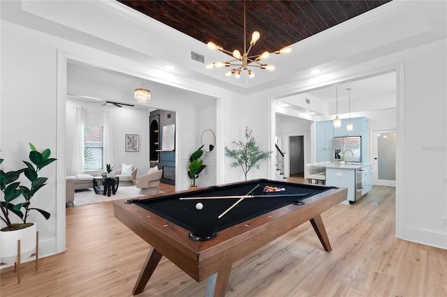 game room with pool table, light hardwood / wood-style floors, wood ceiling, a chandelier, and crown molding