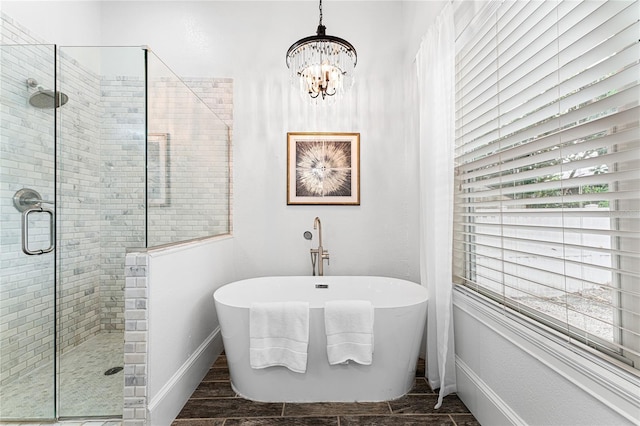 bathroom with plus walk in shower and a chandelier